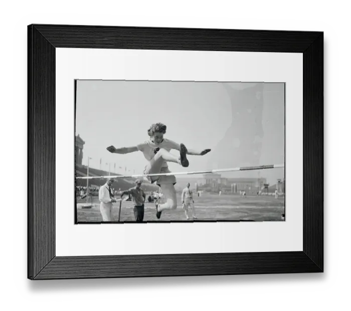 Framed Print : Woman Jumping over Hurdle Framed Print : Woman Jumping over Hurdle