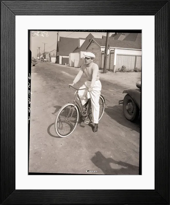 Framed Print : George Raft Seated on Ladies Bicycle Framed Print : George Raft Seated on Ladies Bicycle