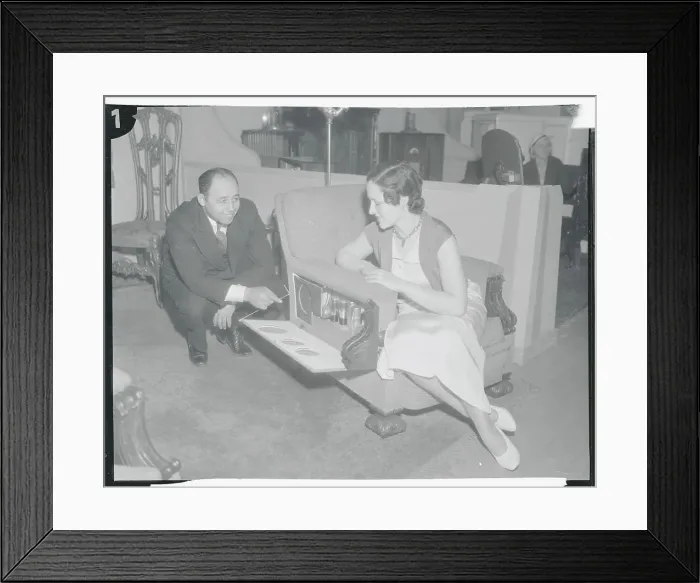 Framed Print : Furniture Designer Louis Davis Demonstrating Chair to Woman Framed Print : Furniture Designer Louis Davis Demonstrating Chair to Woman