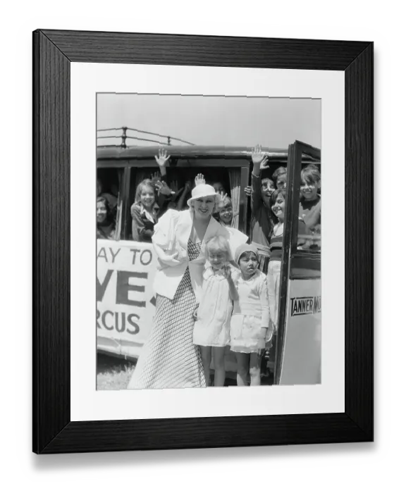 Framed Print : Mae West Posing with Orphans by Circus Bus Framed Print : Mae West Posing with Orphans by Circus Bus
