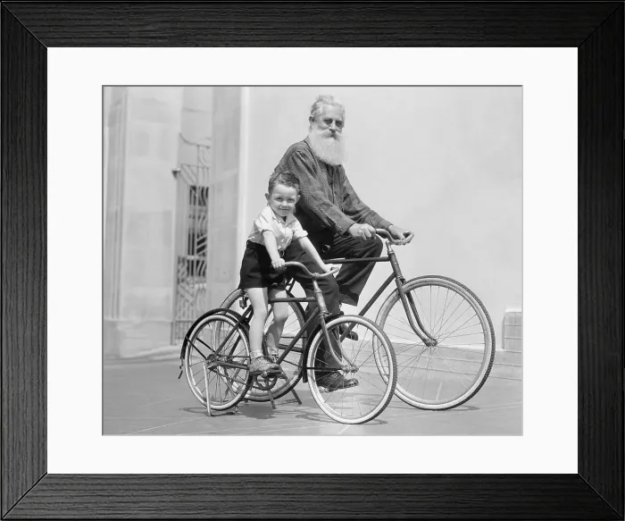 Framed Print : Man and Young Boy Riding Bicycles Framed Print : Man and Young Boy Riding Bicycles