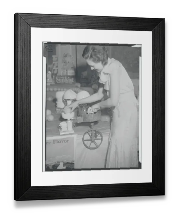 Framed Print : Young Woman Using Early Orange Juice Machine Framed Print : Young Woman Using Early Orange Juice Machine