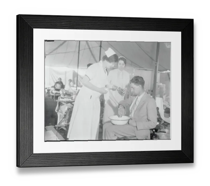 Framed Print : Nurses Tending Injured Man