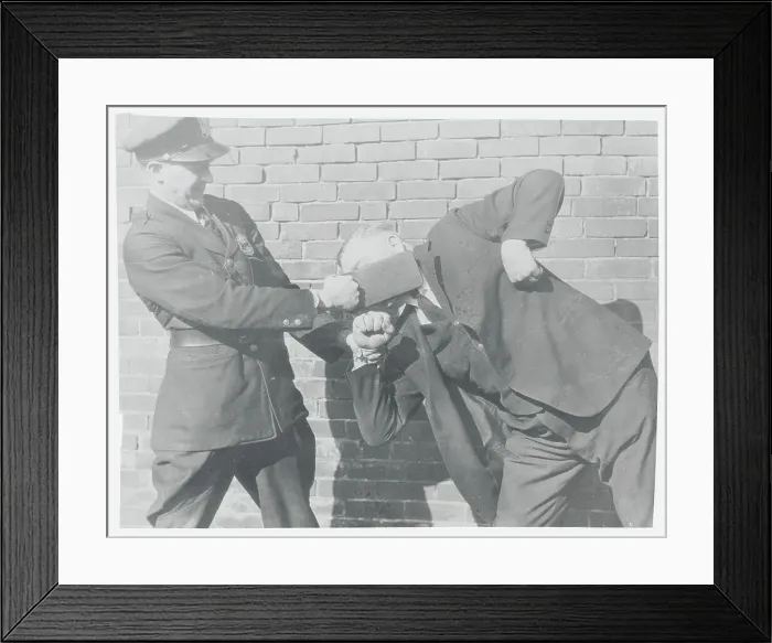 Framed Print : Police Officer Slapping Man in Face