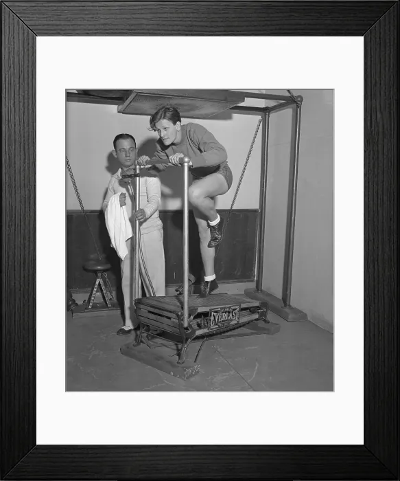 Framed Print : Mildred Didrickson Using Exercise Machine with Artie McGovern Framed Print : Mildred Didrickson Using Exercise Machine with Artie McGovern