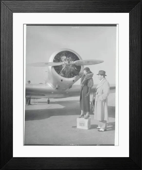 Framed Print : Man and Woman Standing Near Airplane