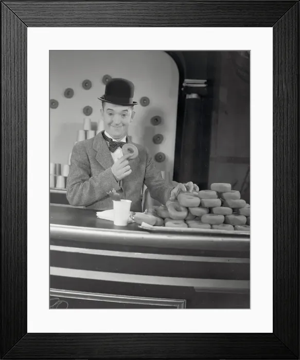 Framed Print : Actor Stan Laurel at Donut Display Framed Print : Actor Stan Laurel at Donut Display