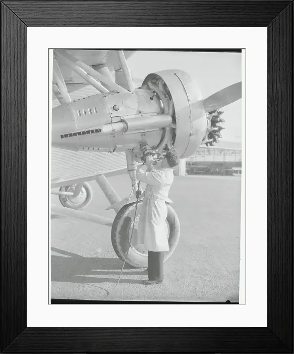 Framed Print : Man Using Portable Airplane Starting Device Framed Print : Man Using Portable Airplane Starting Device