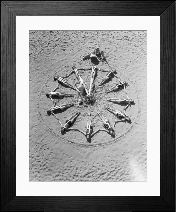 Framed Print : Women Lie on Beach in Shape of Clock Framed Print : Women Lie on Beach in Shape of Clock