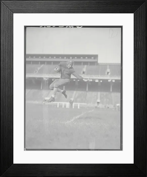 Framed Print : Player Soaring Through Air with Football Framed Print : Player Soaring Through Air with Football
