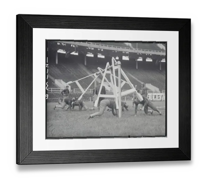 Framed Print : Football Players Practicing with New Tackling Machine