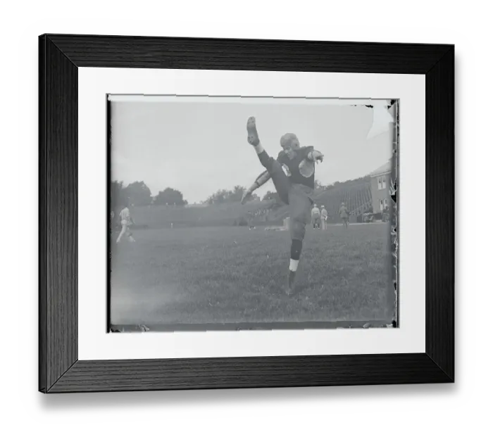 Framed Print : Football Player Practicing His Kicking Framed Print : Football Player Practicing His Kicking