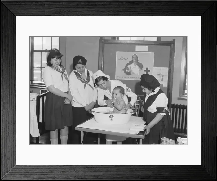 Framed Print : Red Cross Nurse Demonstrating Bathing of Baby to Camp Girls Framed Print : Red Cross Nurse Demonstrating Bathing of Baby to Camp Girls