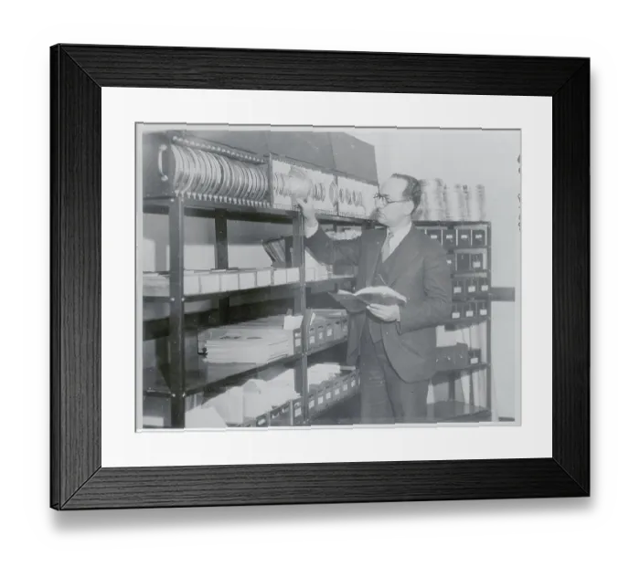 Framed Print : Man Inspecting Reels of Film Framed Print : Man Inspecting Reels of Film