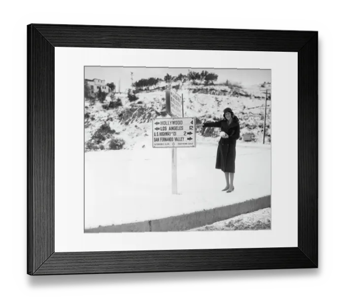 Framed Print : Woman Pointing to Sign in Snowy California Framed Print : Woman Pointing to Sign in Snowy California