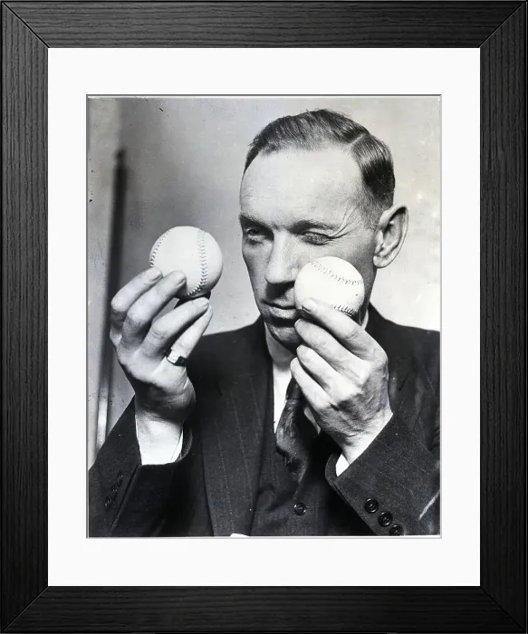 Framed Print : Man Comparing Two Baseballs Framed Print : Man Comparing Two Baseballs