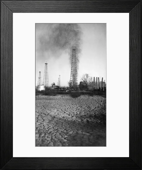 Framed Print : Oil Derrick with Smoke and Oil Shooting Upwards Framed Print : Oil Derrick with Smoke and Oil Shooting Upwards