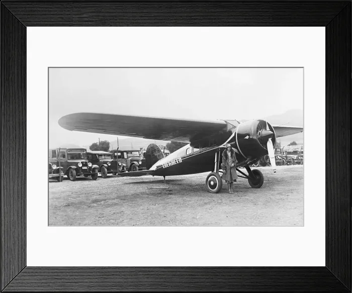 Framed Print : Amelia Earhart Posing Beside Plane Framed Print : Amelia Earhart Posing Beside Plane