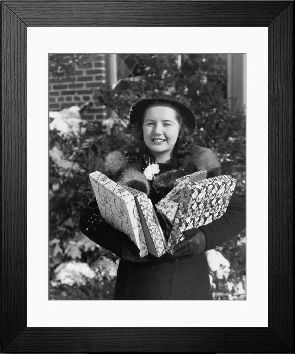 Framed Print : Young Woman Holding Christmas Gifts