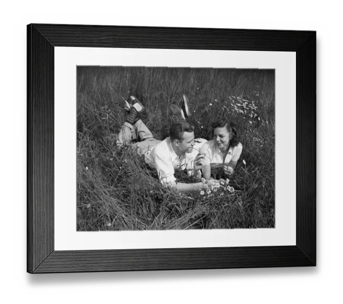 Framed Print : Young Couple Lying in the Grass