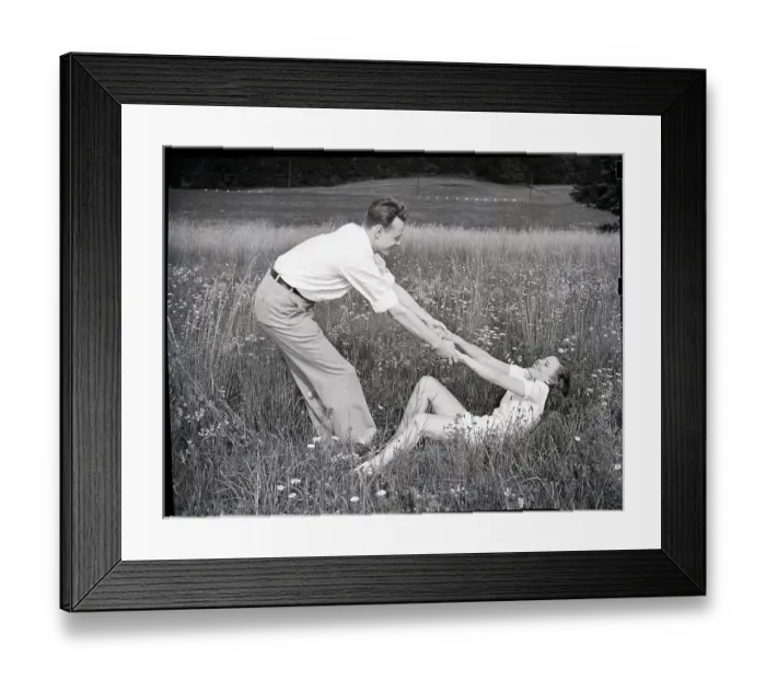 Framed Print : Young Couple Frolicking in Grass Framed Print : Young Couple Frolicking in Grass