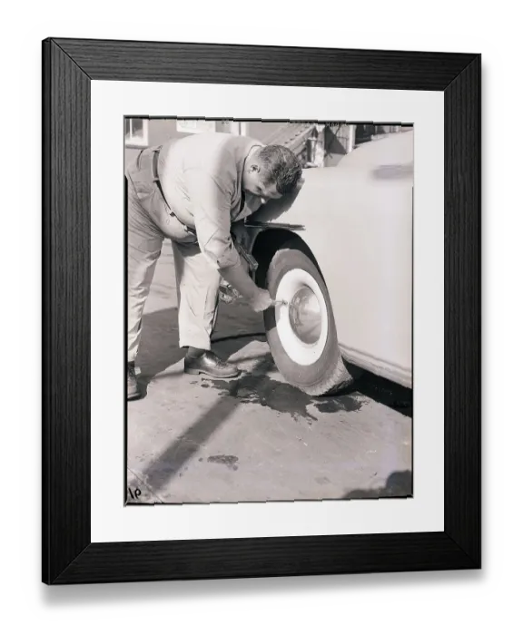 Framed Print : Man Putting Air in Automobile Tire Framed Print : Man Putting Air in Automobile Tire