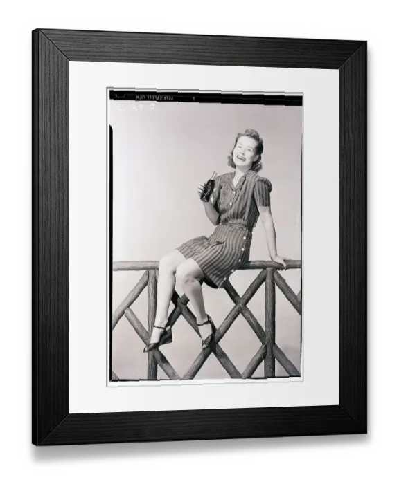 Framed Print : Woman Seated on Fence with Bottle of Soda Framed Print : Woman Seated on Fence with Bottle of Soda