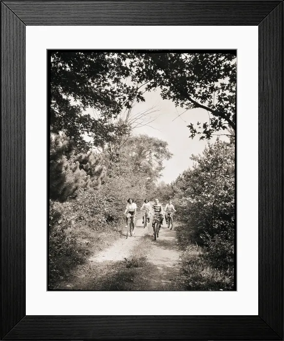 Framed Print : Cyclists Ride Down a Country Road Framed Print : Cyclists Ride Down a Country Road