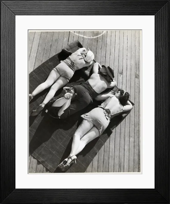 Framed Print : Three Sunbathers on Towel on Deck of Ship