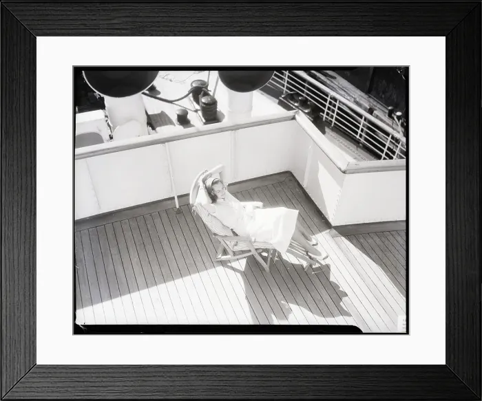 Framed Print : Woman Seated on Lounge Chair on Deck of Ship Framed Print : Woman Seated on Lounge Chair on Deck of Ship