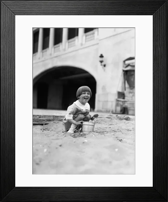 Framed Print : Young girl (4-5 years) playing in sand. June 06, 1929 Framed Print : Young girl (4-5 years) playing in sand. June 06, 1929