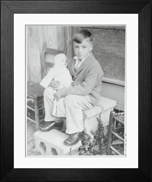Framed Print : Boy Holding a Doll