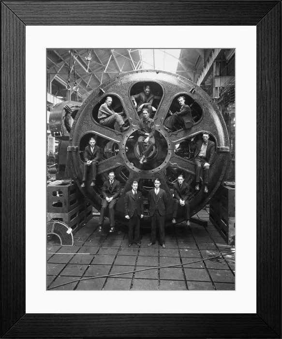 Framed Print : Men Perched Inside Huge Motor Framed Print : Men Perched Inside Huge Motor