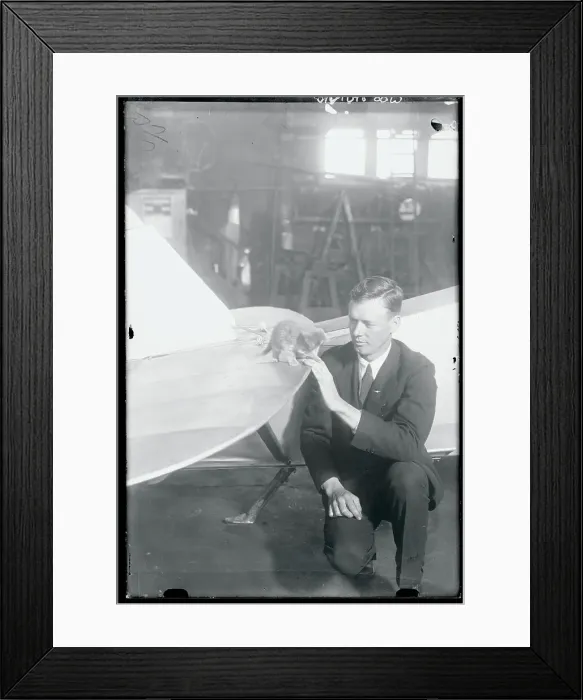Framed Print : Charles Lindbergh Sitting at Airplane With Kitten Mascot on a Wing Framed Print : Charles Lindbergh Sitting at Airplane With Kitten Mascot on a Wing