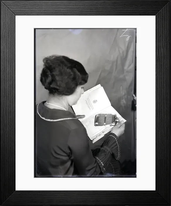 Framed Print : Woman Opening Book Containing Flask Framed Print : Woman Opening Book Containing Flask