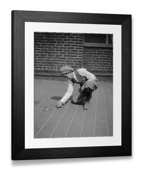 Framed Print : Boy (10-12 years) playing with marbles on pavement. Philadelphia, Pennsylvania, USA. May 06, 1926 Framed Print : Boy (10-12 years) playing with marbles on pavement. Philadelphia, Pennsylvania, USA. May 06, 1926