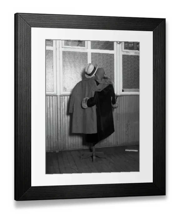 Framed Print : Hanging Coats Posed as an Embracing Couple Framed Print : Hanging Coats Posed as an Embracing Couple