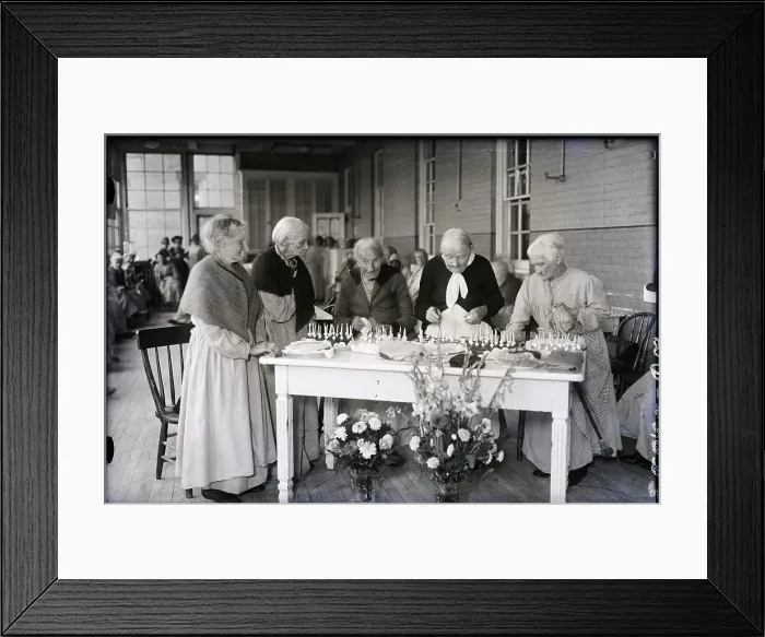 Framed Print : 100-Year-Old Woman Cutting Birthday Cake Framed Print : 100-Year-Old Woman Cutting Birthday Cake