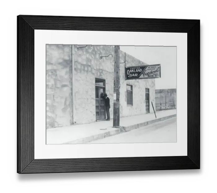 Framed Print : Exterior View of Man Standing at Doorway of Cantina Establishment Framed Print : Exterior View of Man Standing at Doorway of Cantina Establishment