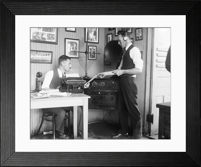 Framed Print : Two Men Exchanging Paper in Office Framed Print : Two Men Exchanging Paper in Office