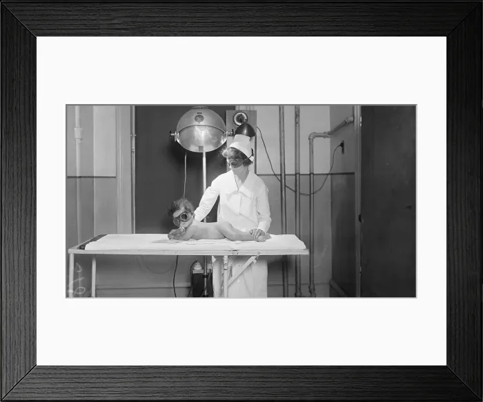 Framed Print : Nurse With Apparatuses by Table With Infant Framed Print : Nurse With Apparatuses by Table With Infant