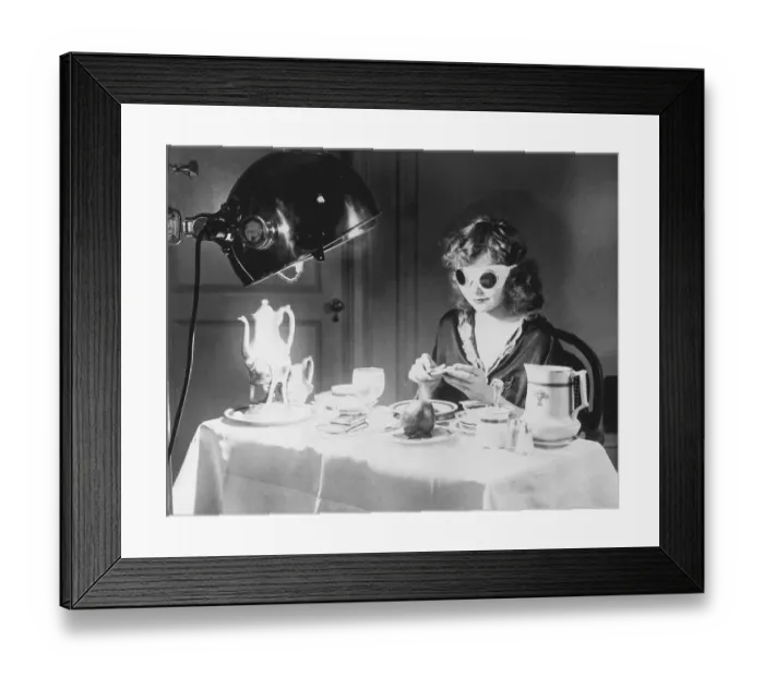 Framed Print : Woman Eating Meal Under an Ultraviolet Lamp