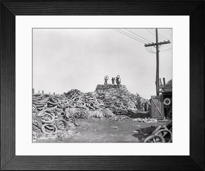 Framed Print : Men Standing on a Pile of Tires