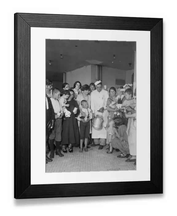Framed Print : Immigration Worker Giving Milk to Woman and Children Framed Print : Immigration Worker Giving Milk to Woman and Children