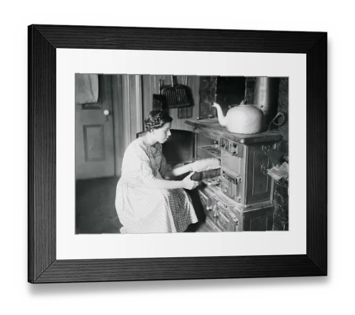 Framed Print : Housekeeper Putting Food in Oven Framed Print : Housekeeper Putting Food in Oven