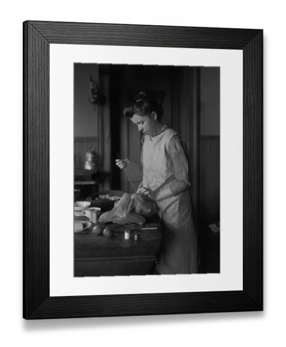 Framed Print : Teenage girl (16-17 years) stuffing turkey. August 06, 1925 Framed Print : Teenage girl (16-17 years) stuffing turkey. August 06, 1925