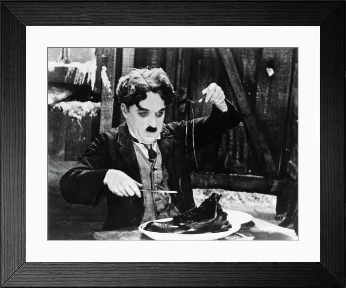 Framed Print : Charlie Chaplin in the Shoe-Eating Scene from The Gold Rush Framed Print : Charlie Chaplin in the Shoe-Eating Scene from The Gold Rush