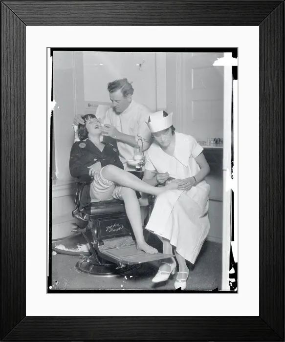 Framed Print : Dentist and Nurse Working on Teeth and Feet Framed Print : Dentist and Nurse Working on Teeth and Feet