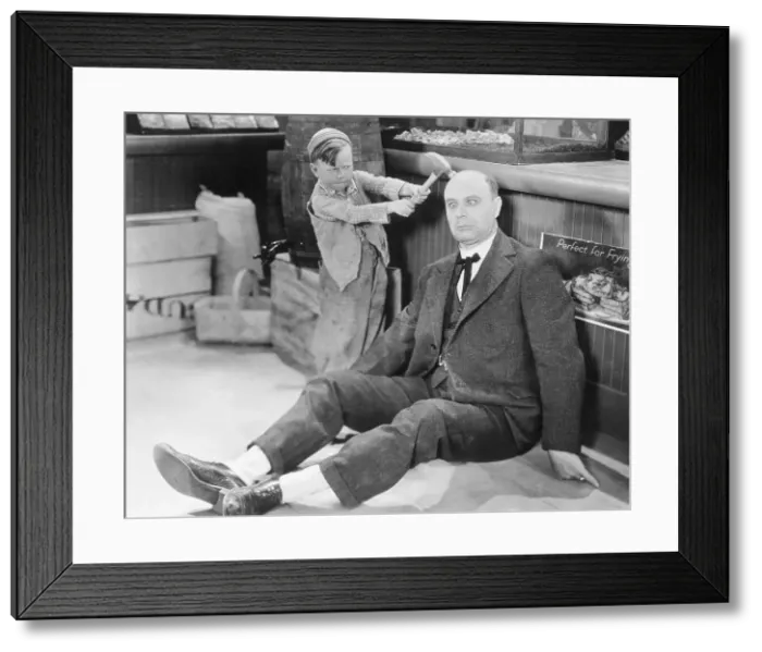 Framed Print : Boy Hitting Man over Head with Hammer Framed Print : Boy Hitting Man over Head with Hammer