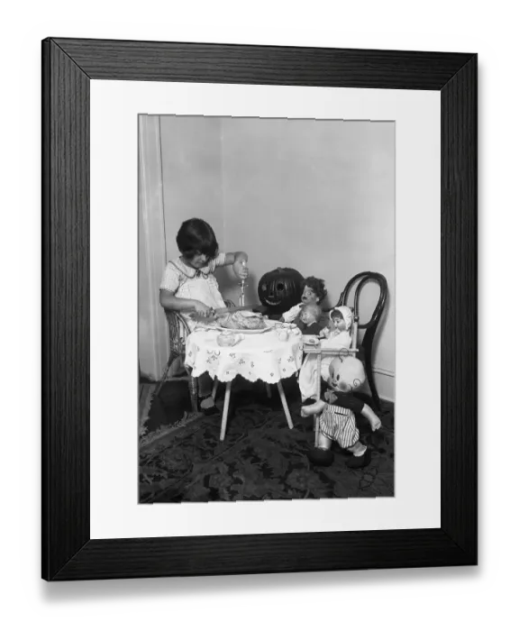 Framed Print : Girl (6-7) dining with her dolls and toys Framed Print : Girl (6-7) dining with her dolls and toys